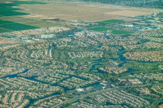 Aerial view of suburban development named in Chandler, Arizona, featuring lakes, lush golf courses, and water-guzzling lawns. Credit: Wild Horizon/Universal Images Group via Getty Images