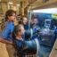 Sandia National Laboratories researchers Leo Small (back right) and Erik Spoerke (back left) observe as Martha Gross (front) works in a glovebox on a new kind of molten-sodium battery. Credit: Randy Montoya