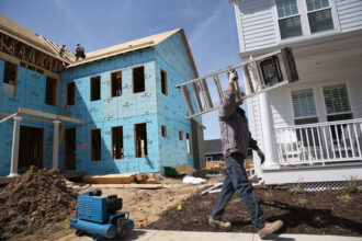 Construction workers work on a housing development on May 3, 2013 in Denver, Colorado. Credit: John Moore/Getty Images