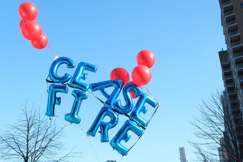 At around 2pm, the protesters launched a set of balloons reading the word "ceasefire" in Columbus Circle, and slowly moved toward Jazz at Lincoln Center where they floated the balloons outside the summit window. Credit: Keerti Gopal/Inside Climate News