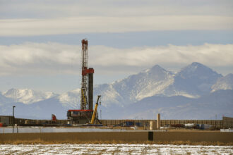 A large fracking operation becomes a new part of the horizon with Mount Meeker and Longs Peak looming in the background on Dec. 28, 2017 in Loveland, Colorado. Credit: Helen H. Richardson/The Denver Post via Getty Images