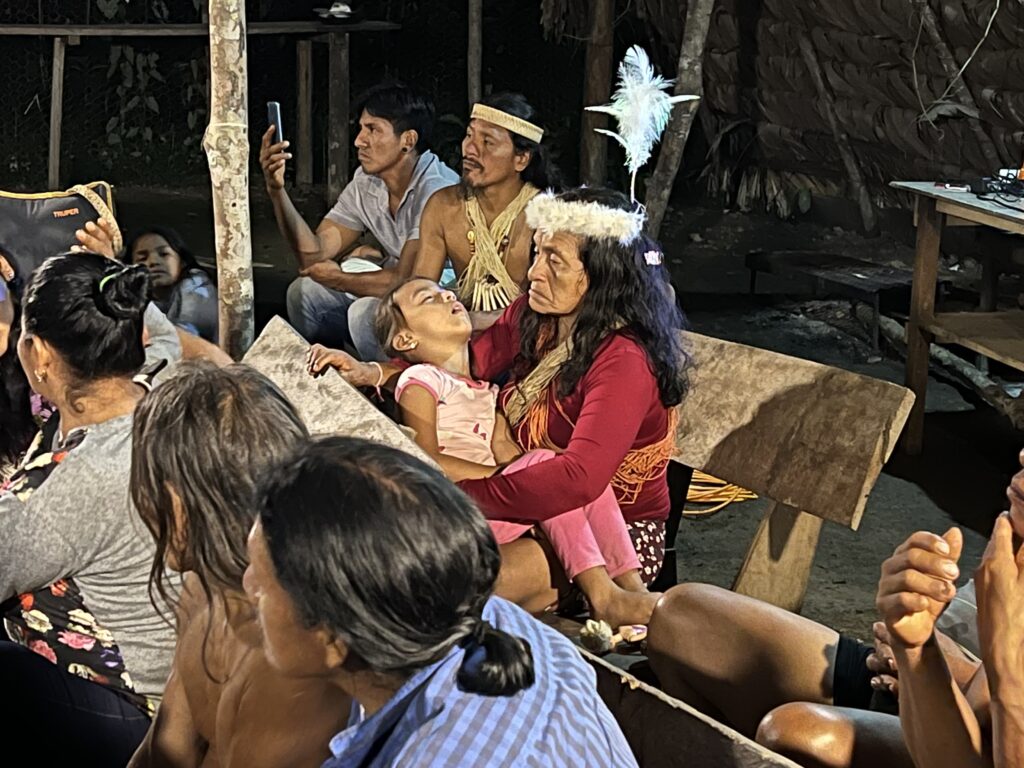 A meeting of recently-contacted Waorani families in Gemenoweno, Ecuador, to discuss a pending Inter-American Court of Human Rights case involving the rights of uncontacted Waorani groups. Credit: Katie Surma/Inside Climate News