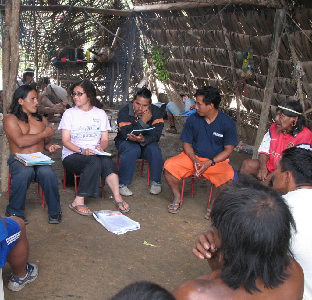 Judith Kimerling and Penti Baihua talk with a group of Waorani people in Bameno, Ecuador on Dec. 30, 2007. Credit: Courtesy of Judith Kimerling