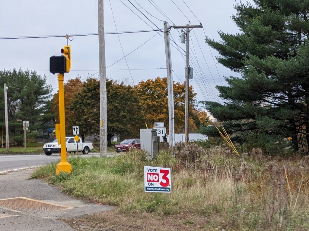 A political sign in Warren, Maine opposes the nonprofit electric utility proposed for the state. Credit: Annie Ropeik