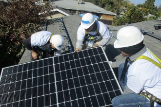 Volunteers for the nonprofit Grid Alternatives install solar panels on a house in Farmersville, California. Credit: Grid Alternatives